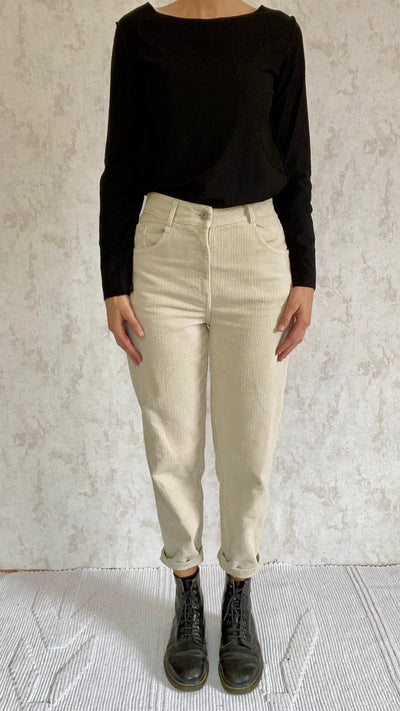 A woman wearing Cordhose retro 1990 made in Italy beige pants.