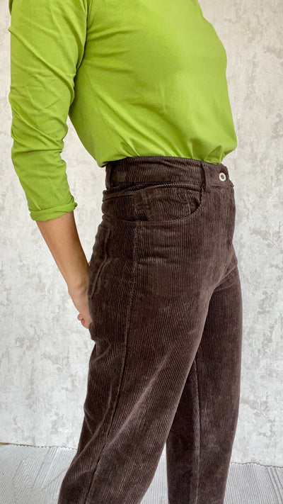 A woman wearing a Cordhose retro 1990 pants made in Italy.