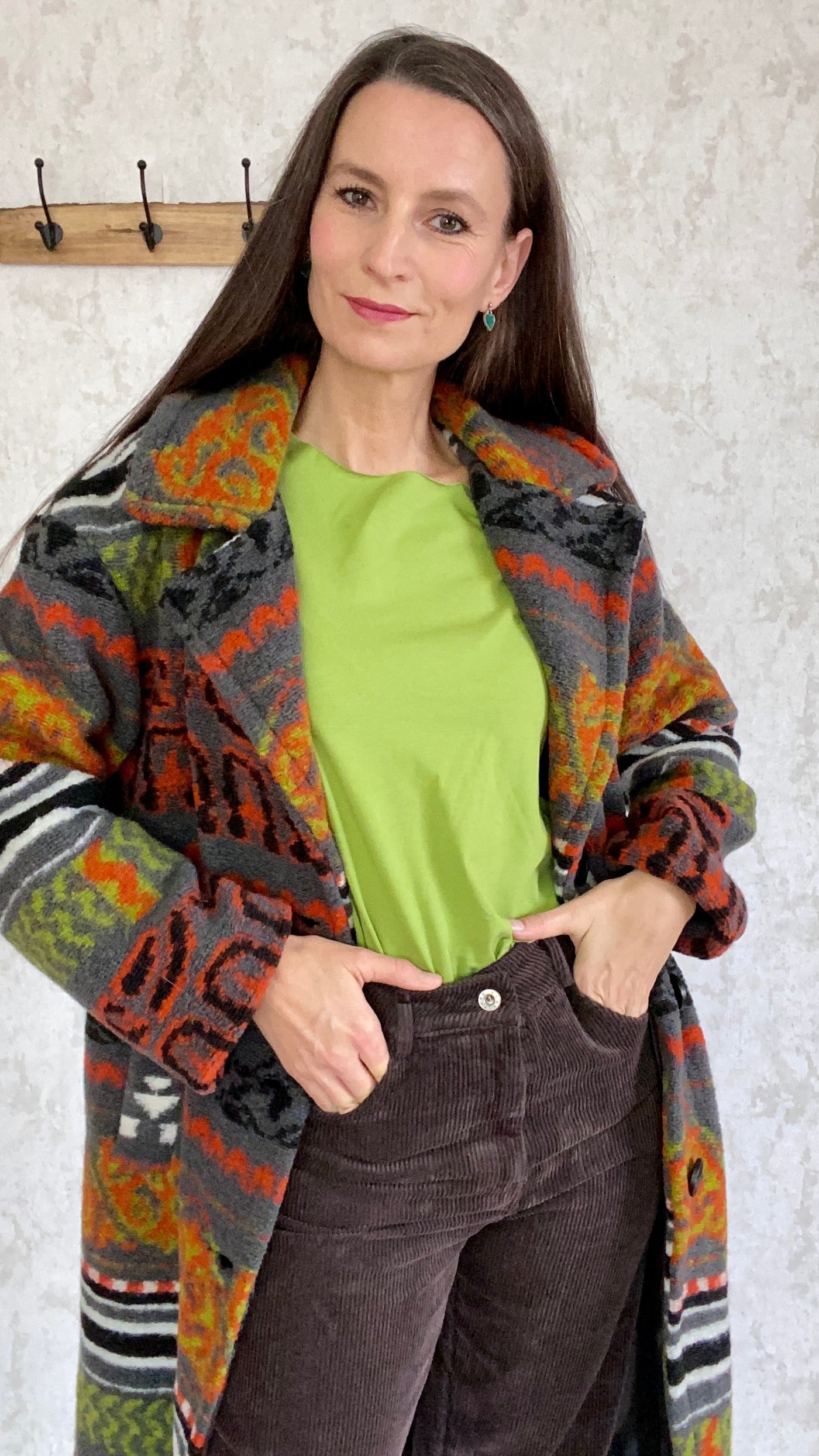 Schöner Azteken Mantel mit Muster orange, schwarz und grün.